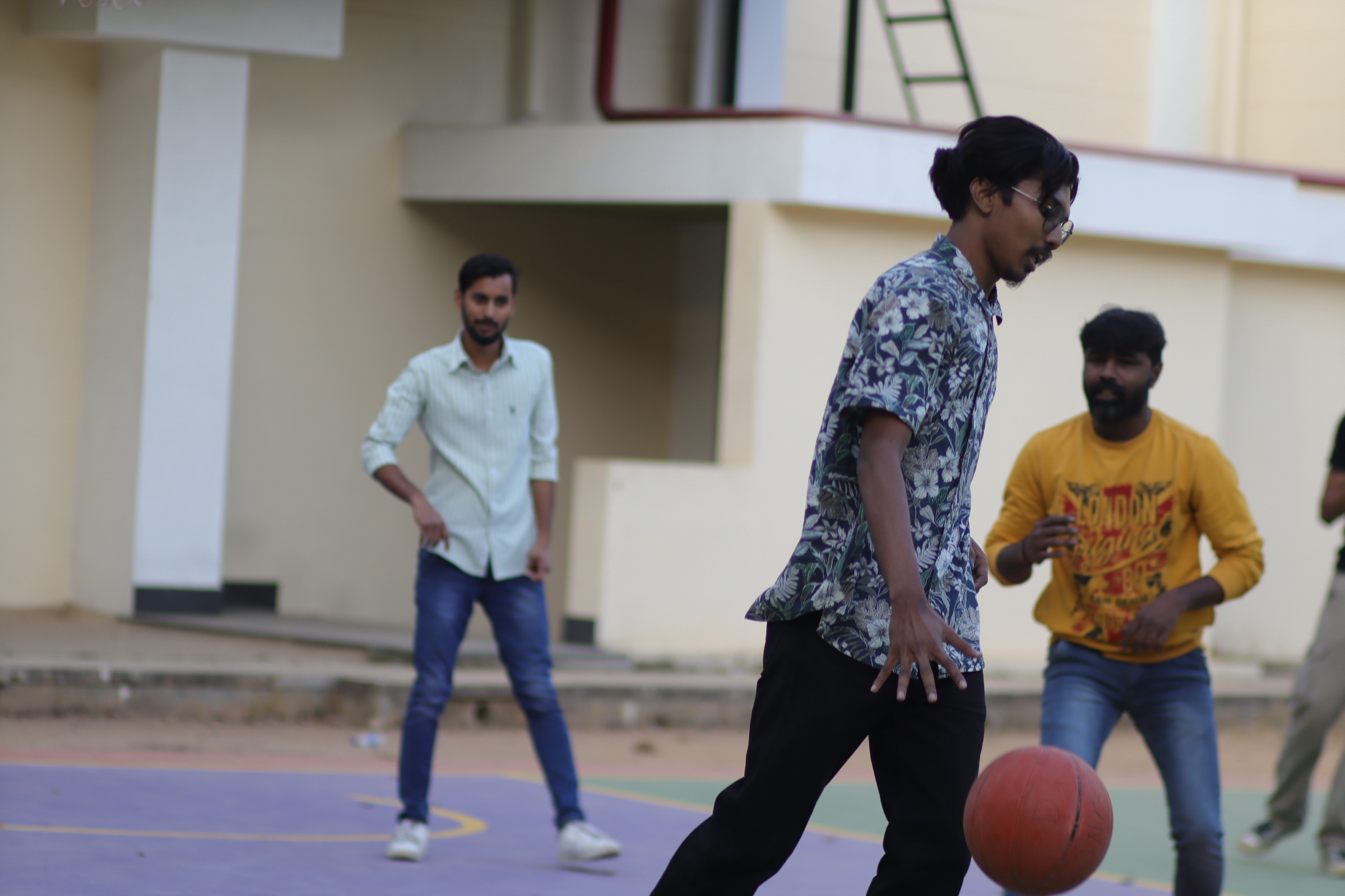 Friends playing basketball on an outdoor court