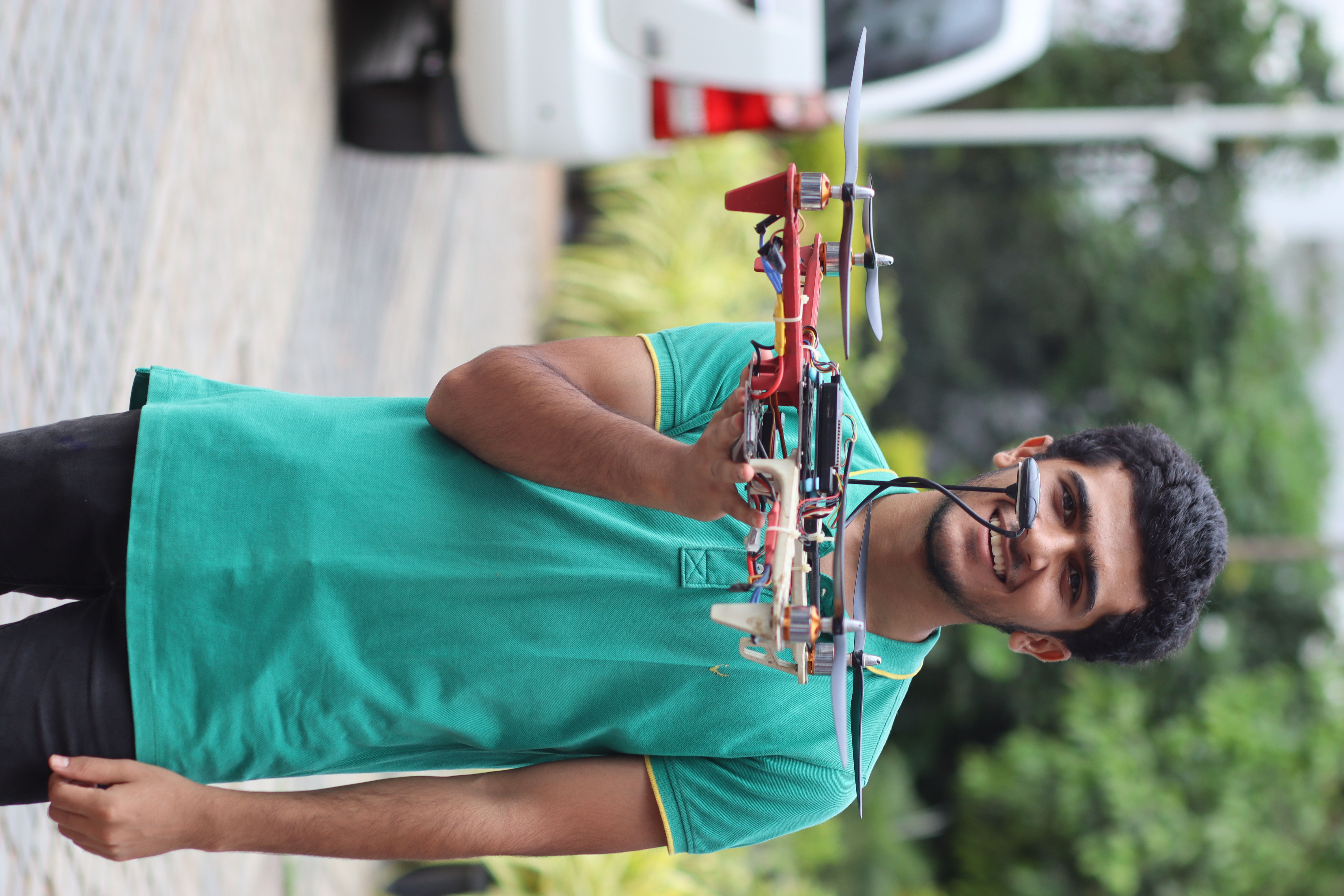 A student holding a handmade drone