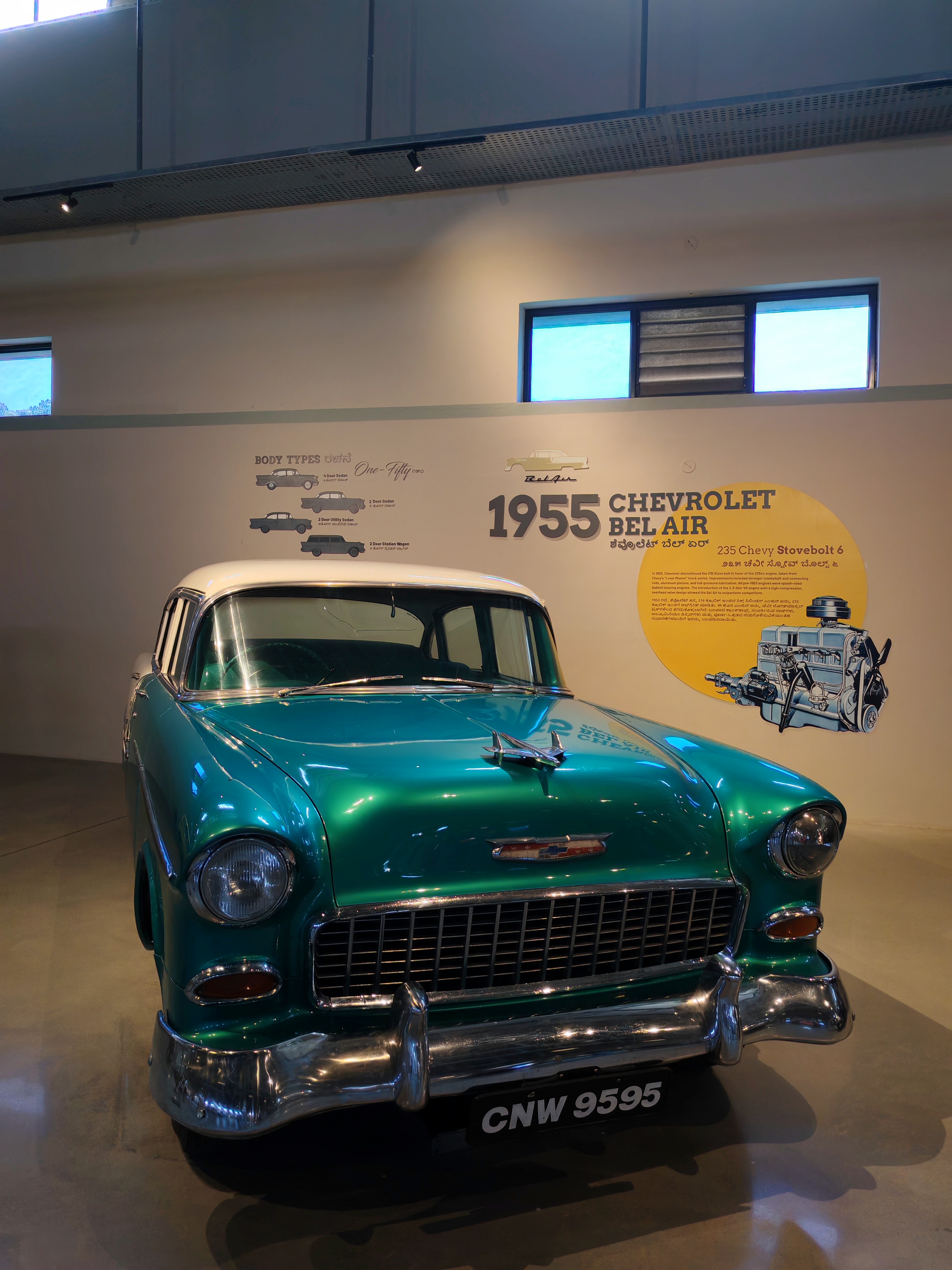 A green 1955 Chevrolet displayed in a museum