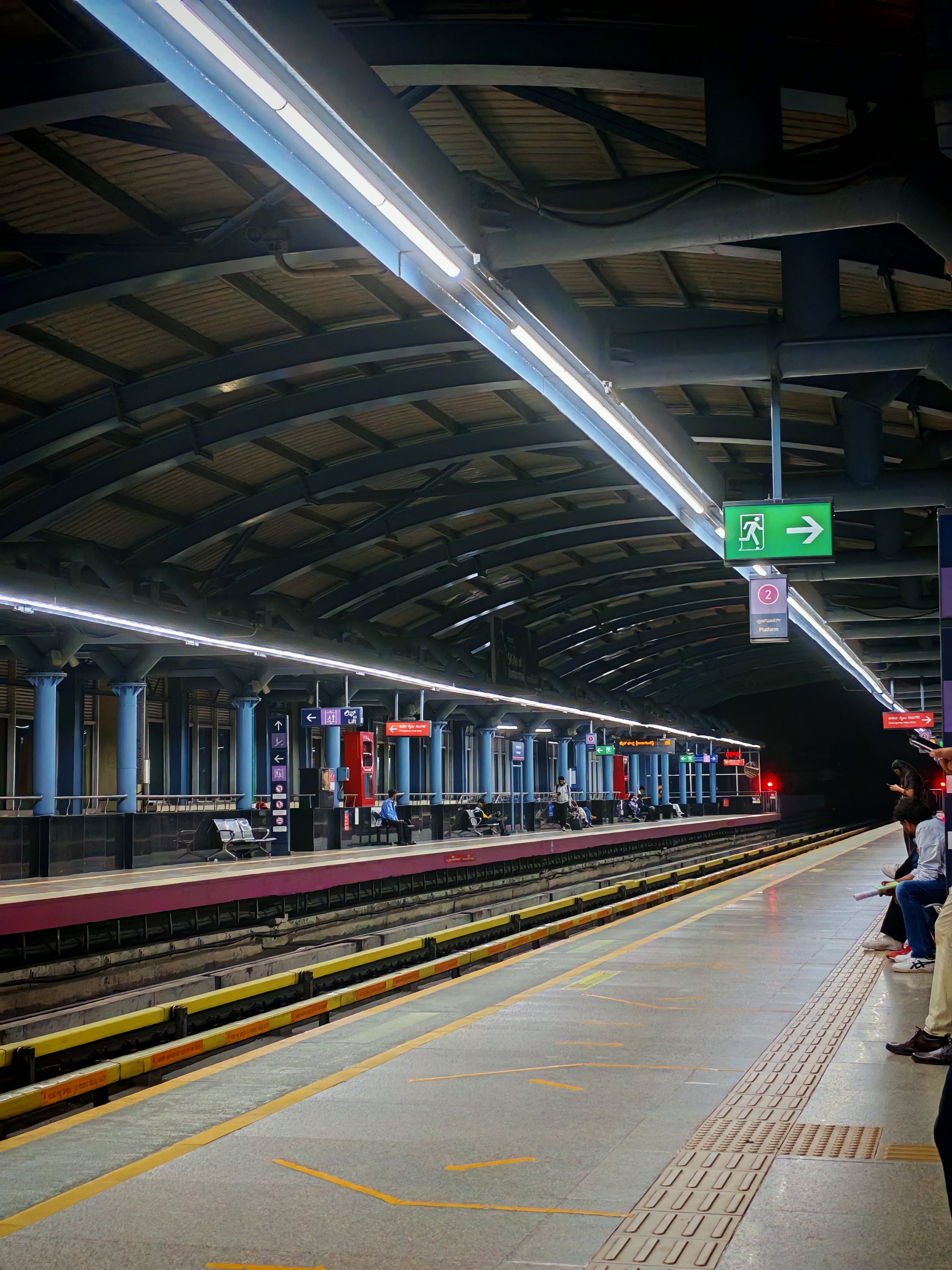 A metro platform under fluorescent lights